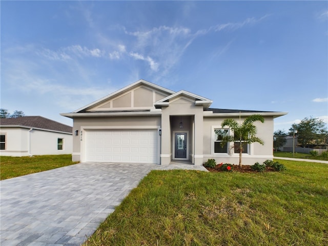 view of front of home with a garage and a front yard