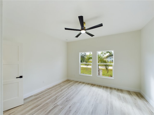 unfurnished room with light wood-type flooring and ceiling fan