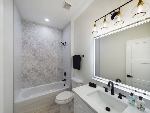 full bathroom featuring hardwood / wood-style flooring, vanity, toilet, and tiled shower / bath