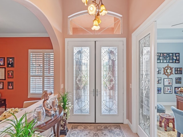 foyer entrance featuring crown molding and french doors