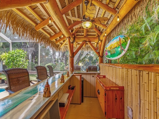 unfurnished sunroom featuring ceiling fan