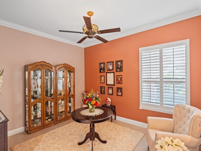 sitting room with ceiling fan and crown molding