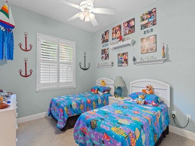 tiled bedroom featuring ceiling fan