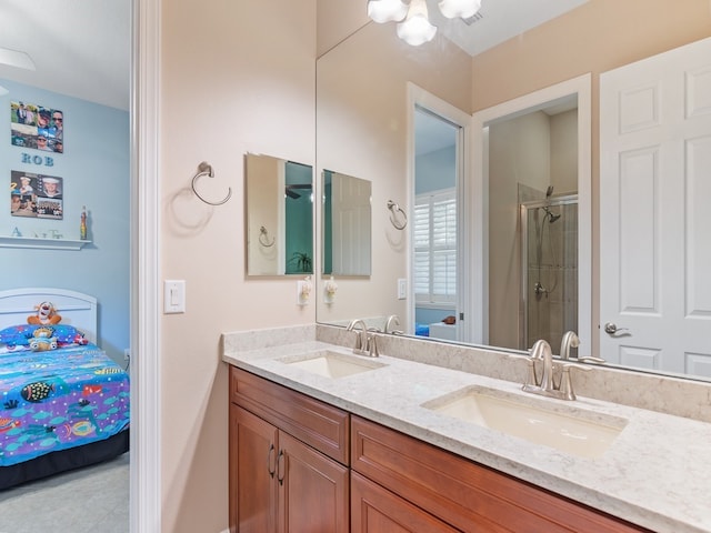 bathroom with vanity and a shower with door