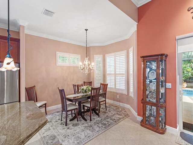 dining space featuring ornamental molding, a healthy amount of sunlight, and a notable chandelier