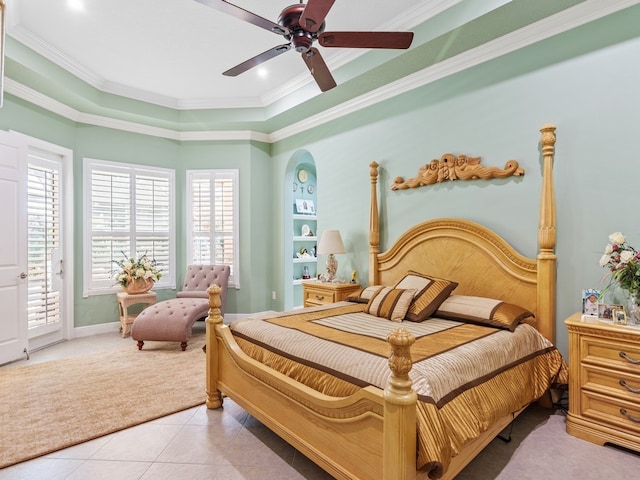 tiled bedroom with ceiling fan, a raised ceiling, ornamental molding, and access to outside