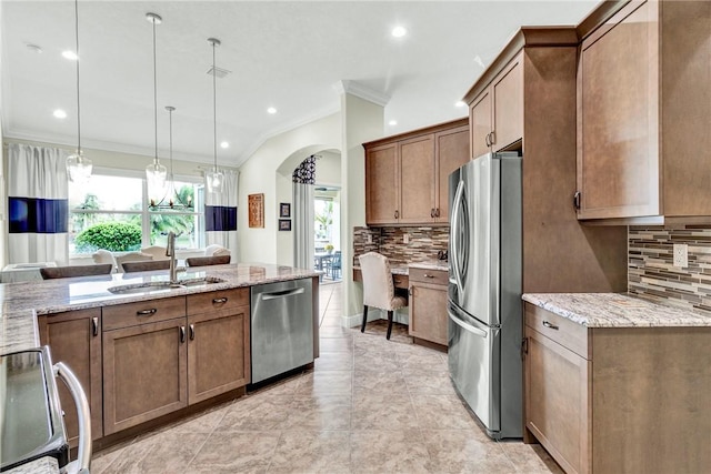 777 Fortunella Cir SW, Vero Beach, FL 32968 - kitchen with a sink, arched walkways, appliances with stainless steel finishes, crown molding, and light stone countertops