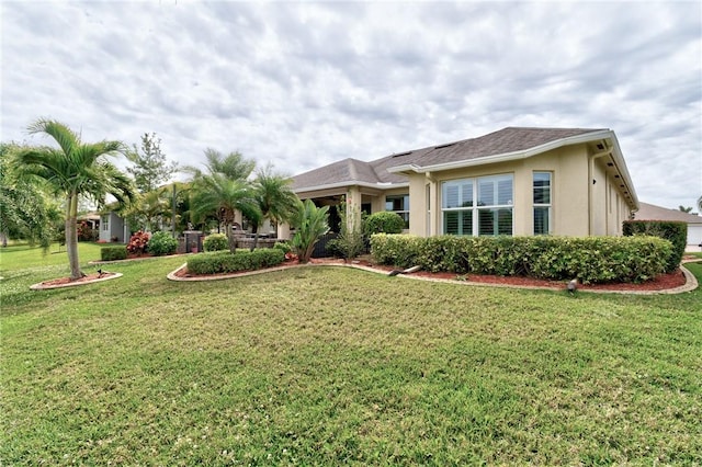 777 Fortunella Cir SW, Vero Beach, FL 32968 - exterior space featuring stucco siding and a lawn