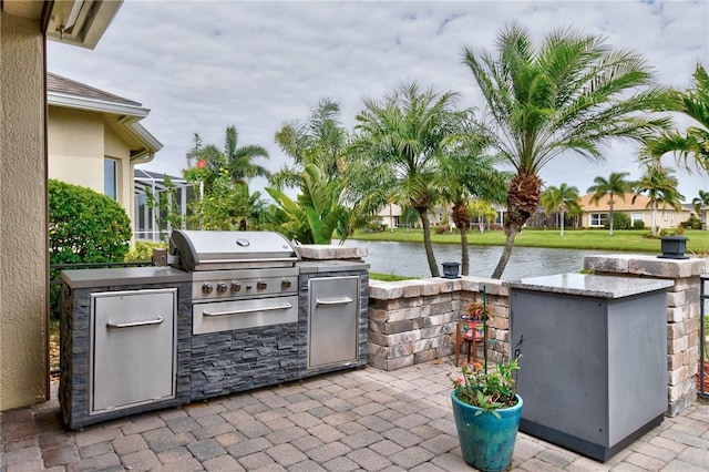 777 Fortunella Cir SW, Vero Beach, FL 32968 - view of patio / terrace with a grill, exterior kitchen, and a water view
