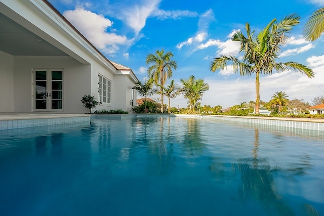 view of pool featuring french doors