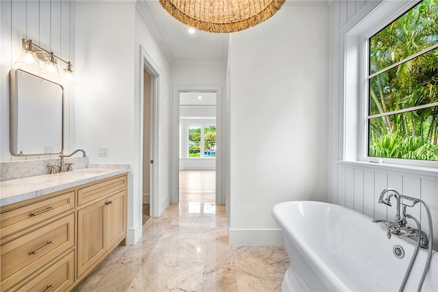 bathroom with vanity and a tub