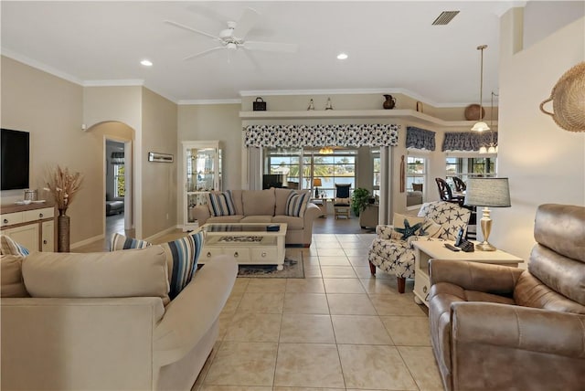 living room with light tile patterned floors, ceiling fan, and ornamental molding