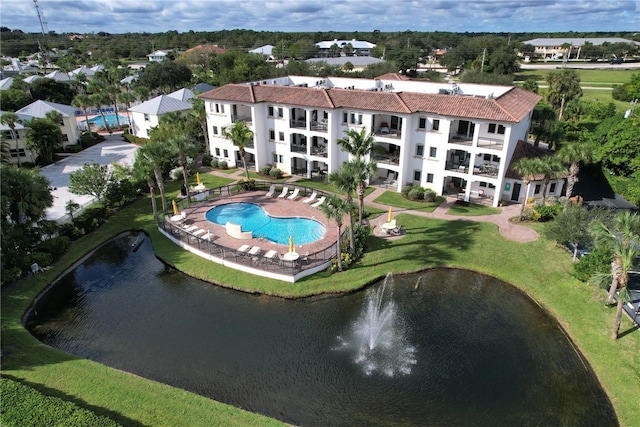 view of pool featuring a water view and a yard