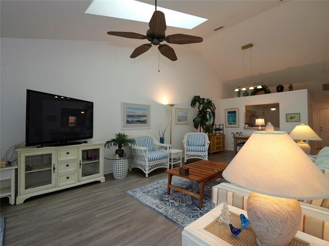 679 5th Ave, Vero Beach, FL 32962 - living room with a skylight, visible vents, dark wood finished floors, high vaulted ceiling, and ceiling fan