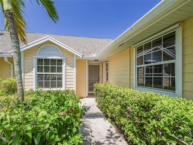 679 5th Ave, Vero Beach, FL 32962 - property entrance featuring roof with shingles