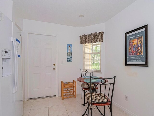 679 5th Ave, Vero Beach, FL 32962 - dining area with light tile patterned flooring and baseboards