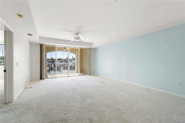 carpeted spare room with ceiling fan