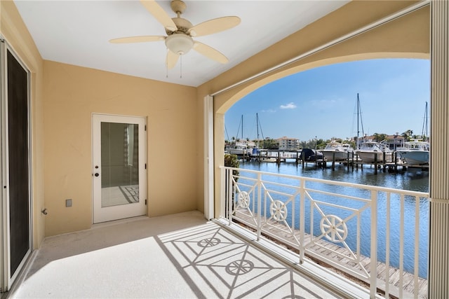 interior space featuring ceiling fan and a water view