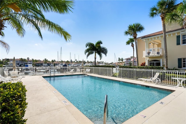 view of pool with a patio and a water view