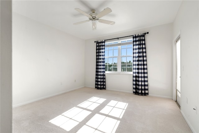 unfurnished room featuring ceiling fan and light colored carpet