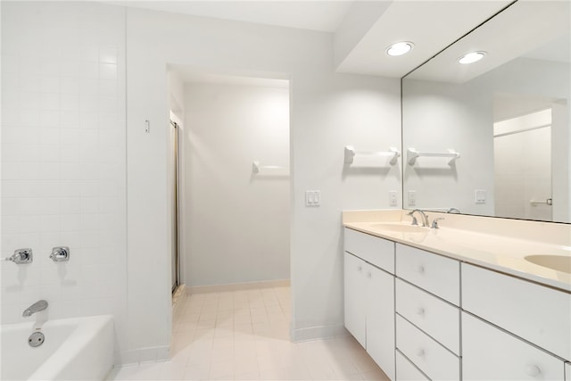 bathroom with vanity, tile patterned floors, and tiled shower / bath