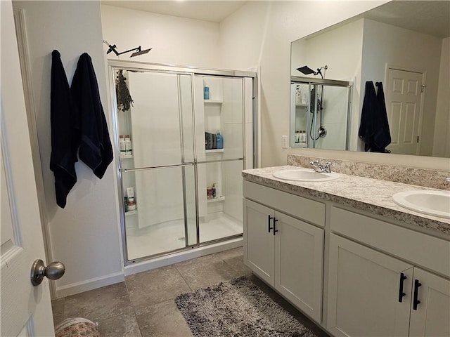 bathroom with tile patterned floors, vanity, and a shower with door