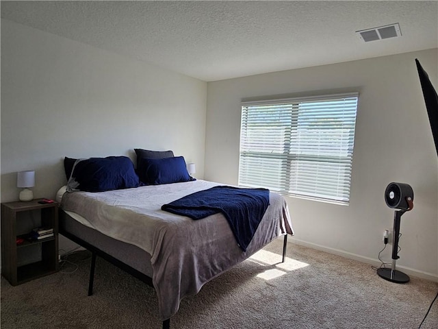 carpeted bedroom with a textured ceiling