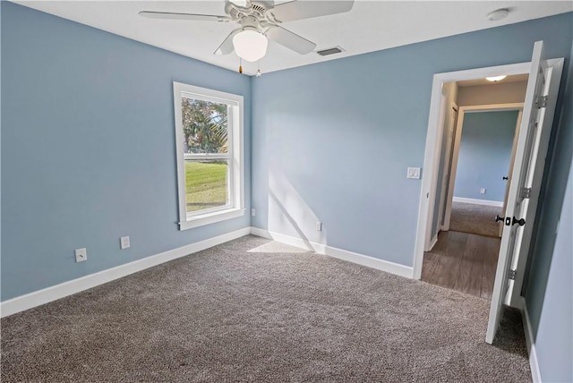 unfurnished room with carpet and ceiling fan