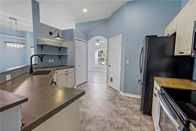 kitchen with pendant lighting, sink, ceiling fan, decorative backsplash, and white cabinetry