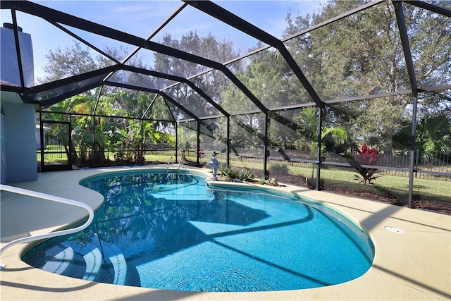 view of swimming pool featuring a lanai and a patio