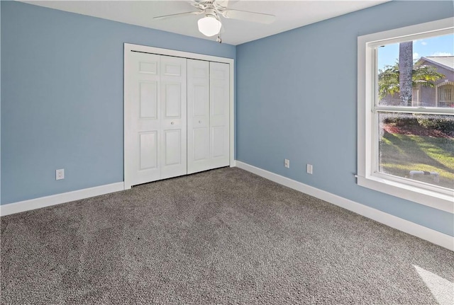 unfurnished bedroom with ceiling fan, a closet, and carpet