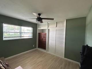 857 Dolores St, Sebastian, FL 32958 - unfurnished bedroom featuring wood finished floors, ceiling fan, and a closet