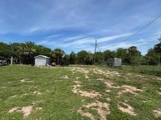 857 Dolores St, Sebastian, FL 32958 - view of yard with a storage unit