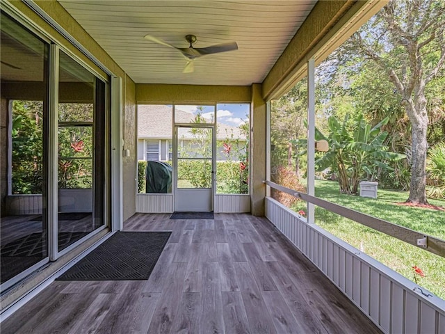 unfurnished sunroom featuring ceiling fan