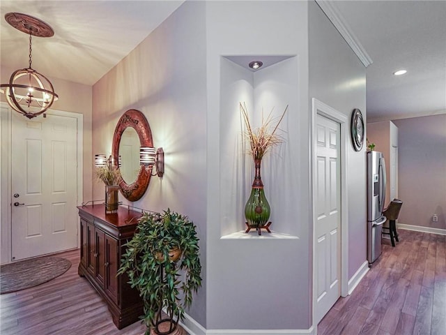 foyer with dark wood-style floors, recessed lighting, an inviting chandelier, and baseboards