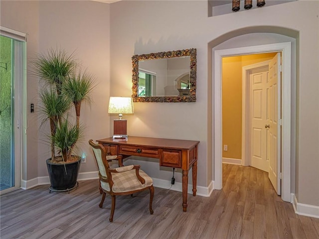 office space featuring baseboards and wood finished floors