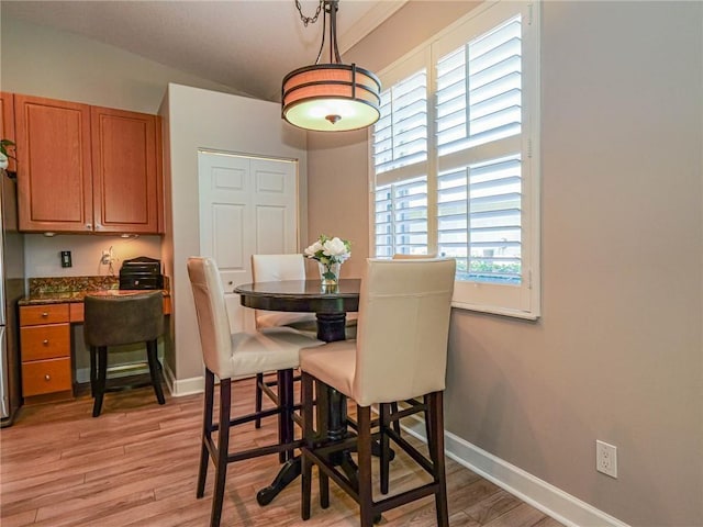 dining room with light wood-style floors and baseboards