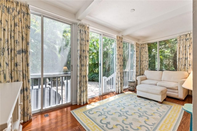 1300 Ivy Ct Unit 209, Vero Beach, FL 32963 - sunroom / solarium featuring beam ceiling, plenty of natural light, and wood finished floors
