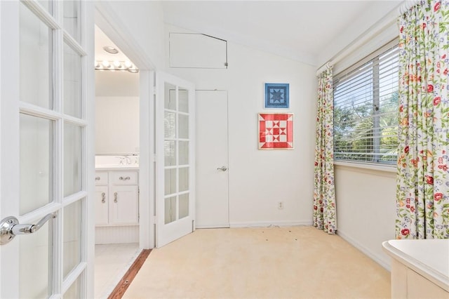 1300 Ivy Ct Unit 209, Vero Beach, FL 32963 - bathroom featuring vanity, lofted ceiling, baseboards, and french doors