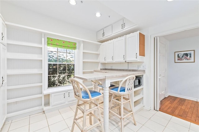 1300 Ivy Ct Unit 209, Vero Beach, FL 32963 - dining space with light tile patterned floors, recessed lighting, and baseboards