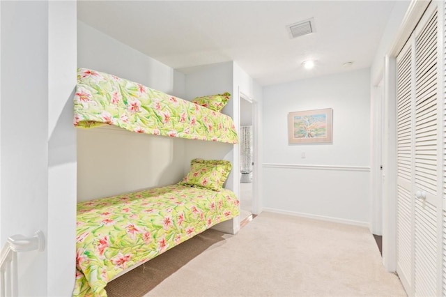 1300 Ivy Ct Unit 209, Vero Beach, FL 32963 - bedroom featuring carpet flooring, a closet, and baseboards