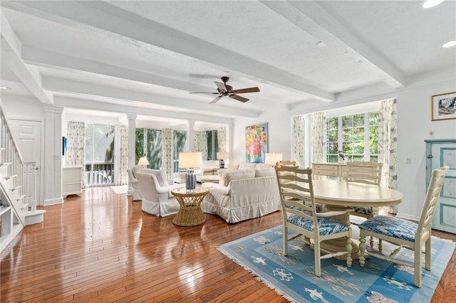 1300 Ivy Ct Unit 209, Vero Beach, FL 32963 - dining area featuring stairs, beamed ceiling, ceiling fan, hardwood / wood-style floors, and decorative columns