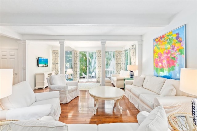 1300 Ivy Ct Unit 209, Vero Beach, FL 32963 - living area featuring ornate columns, beamed ceiling, and hardwood / wood-style floors