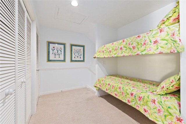 1300 Ivy Ct Unit 209, Vero Beach, FL 32963 - bedroom featuring carpet flooring, attic access, a closet, and baseboards