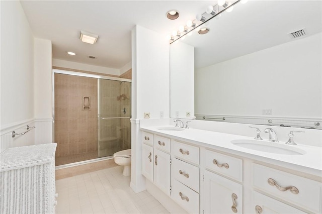 1300 Ivy Ct Unit 209, Vero Beach, FL 32963 - bathroom featuring a shower stall, toilet, double vanity, and tile patterned floors