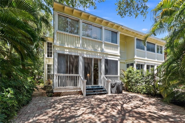 1300 Ivy Ct Unit 209, Vero Beach, FL 32963 - rear view of house featuring a patio area