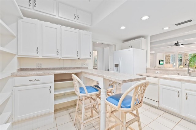1300 Ivy Ct Unit 209, Vero Beach, FL 32963 - kitchen featuring a sink, white appliances, open shelves, white cabinets, and light tile patterned floors