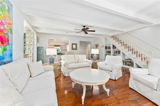 1300 Ivy Ct Unit 209, Vero Beach, FL 32963 - living room featuring wood finished floors, stairs, beam ceiling, ceiling fan, and built in shelves