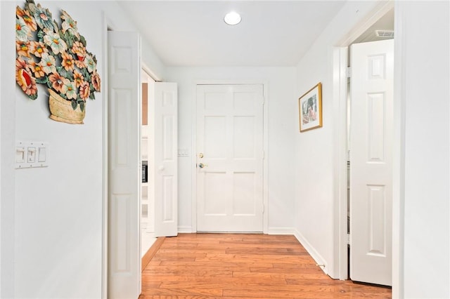 1300 Ivy Ct Unit 209, Vero Beach, FL 32963 - corridor with light wood-style floors and baseboards