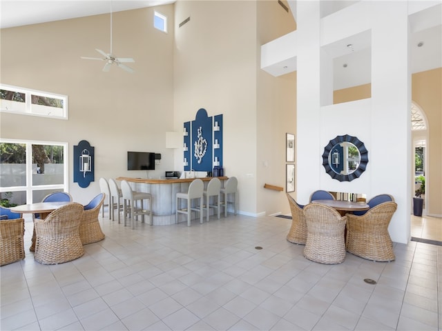 interior space featuring high vaulted ceiling and ceiling fan